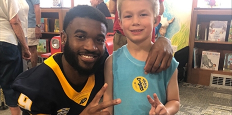 Larry Stephens, a senior wide receiver at the University of Toledo, overcame initial challenges with his cochlear implant to excel in football and academics. Born with a condition leading to deafness, he adapted to the implant, thriving in sports with a specialized helmet and becoming a role model, especially for the deaf community. Balancing his football ambitions with serious academic goals, Stephens is set to graduate in marketing and potentially pursue an MBA, embodying the spirit and resilience of a typical Toledo Football player.