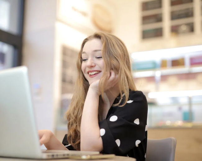 young women on laptop smiling 