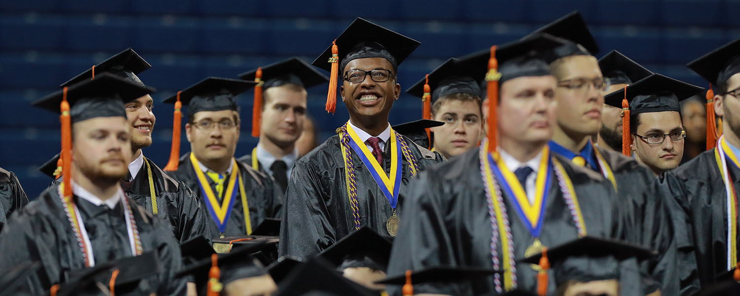 UToledo Graduates in caps and gowns smiling