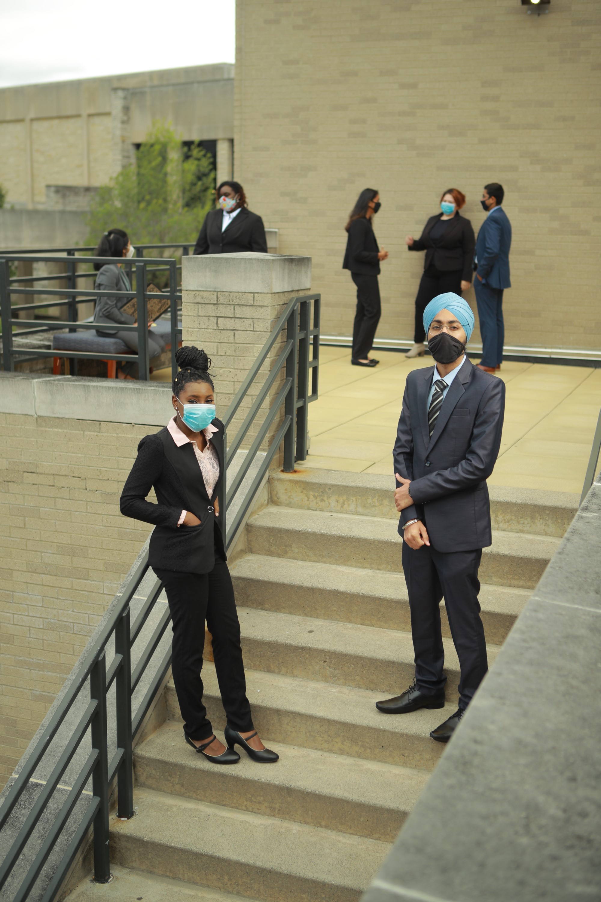 student in professional wear standing in groups 