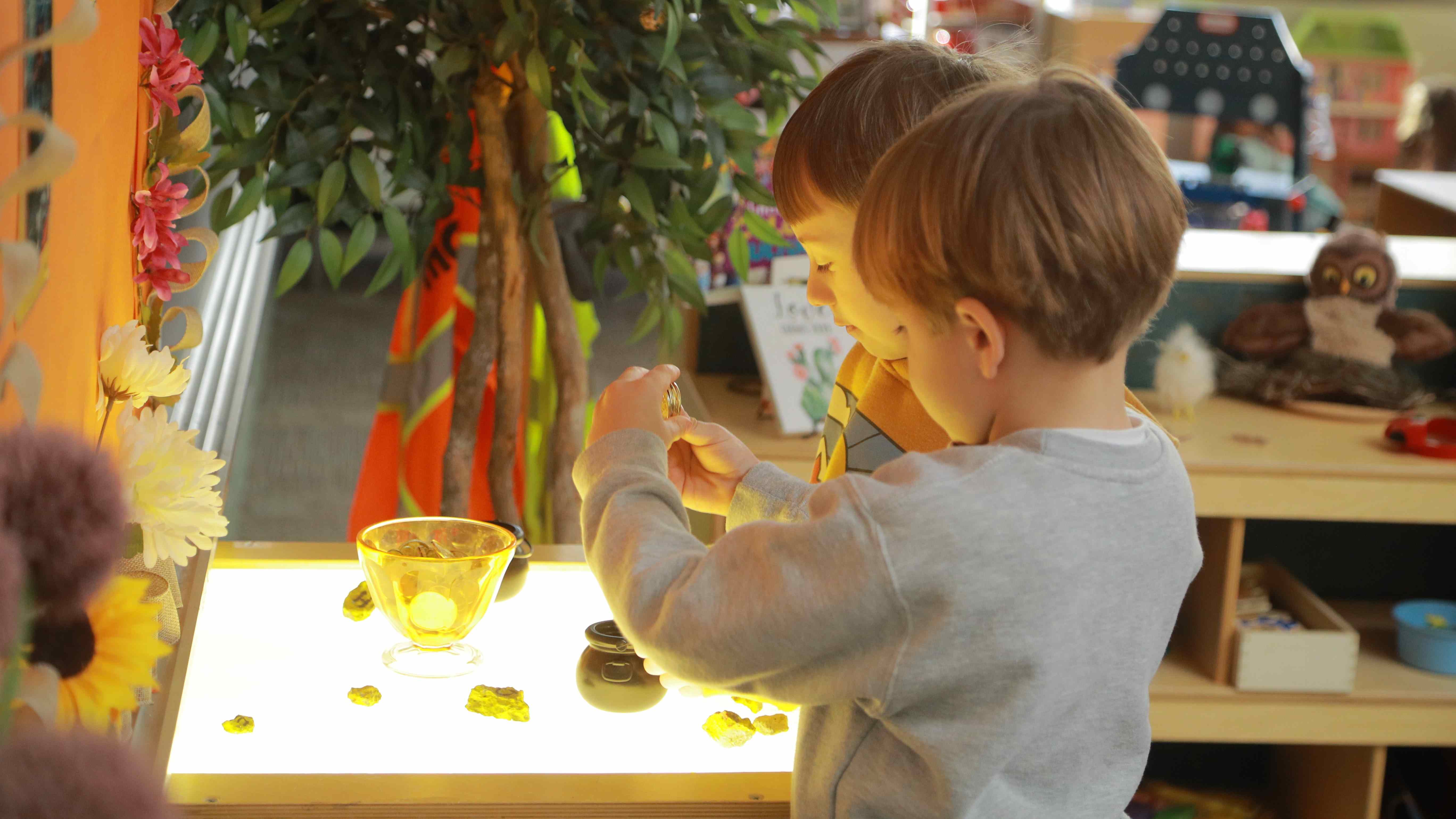 children playing at light table
