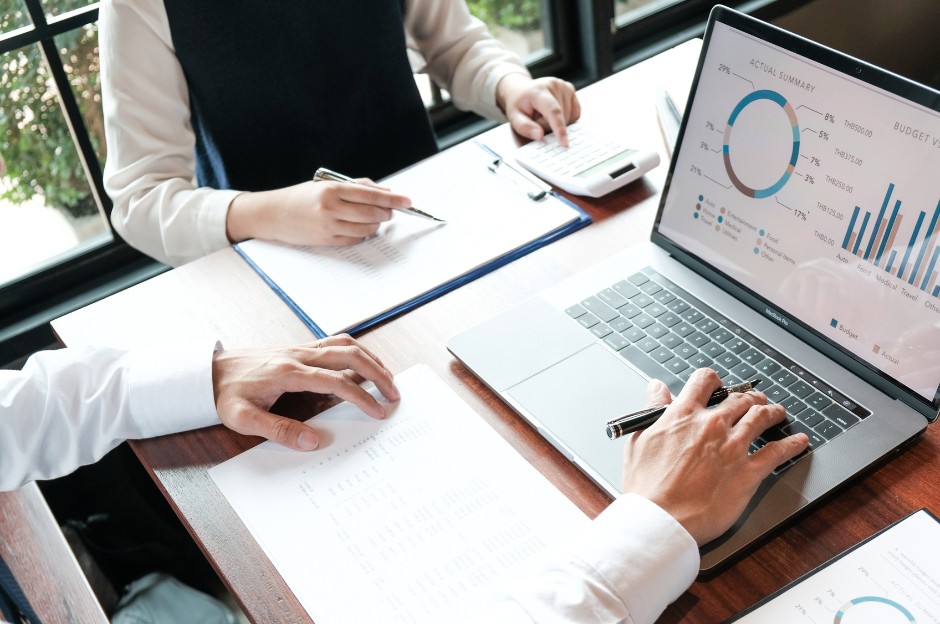 Two people working at a table reviewing data