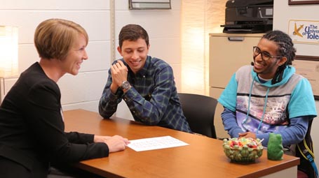 Sara Clark with two students