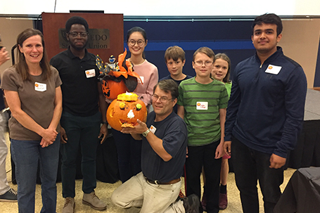 students around their carved pumpkin