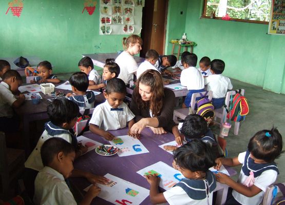 person teaching in a classroom abroad