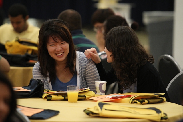 Two international students happily talking with each other