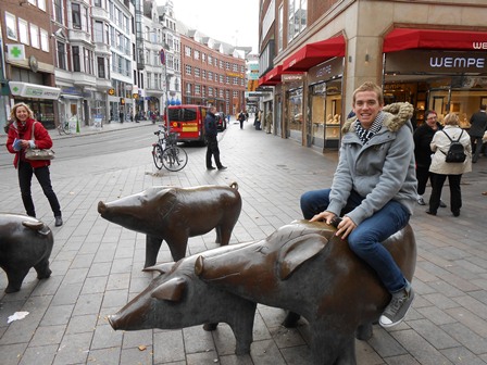 Student rides a pig sculpture