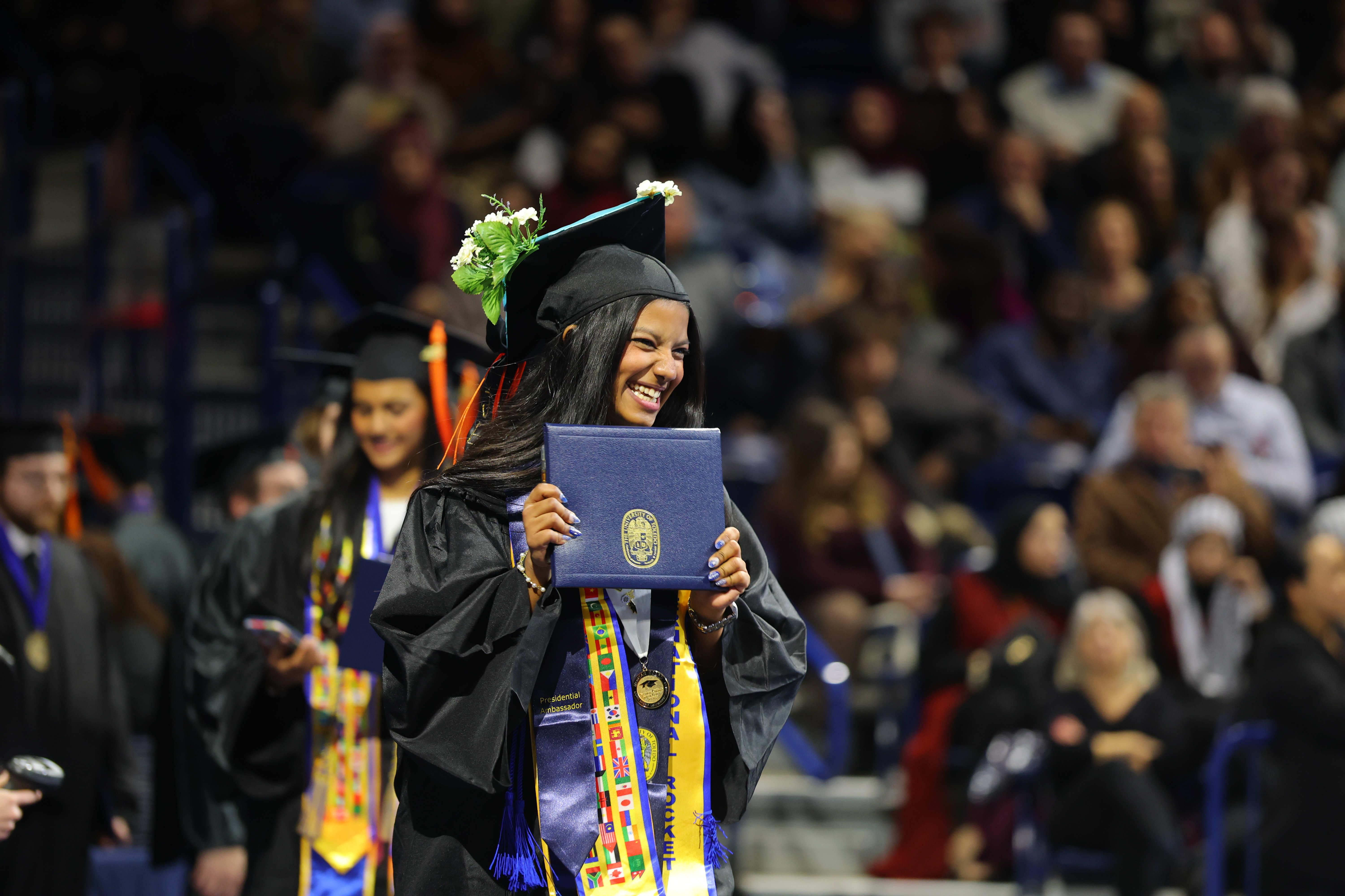 UToledo graduate with diploma p.m. commencement ceremony