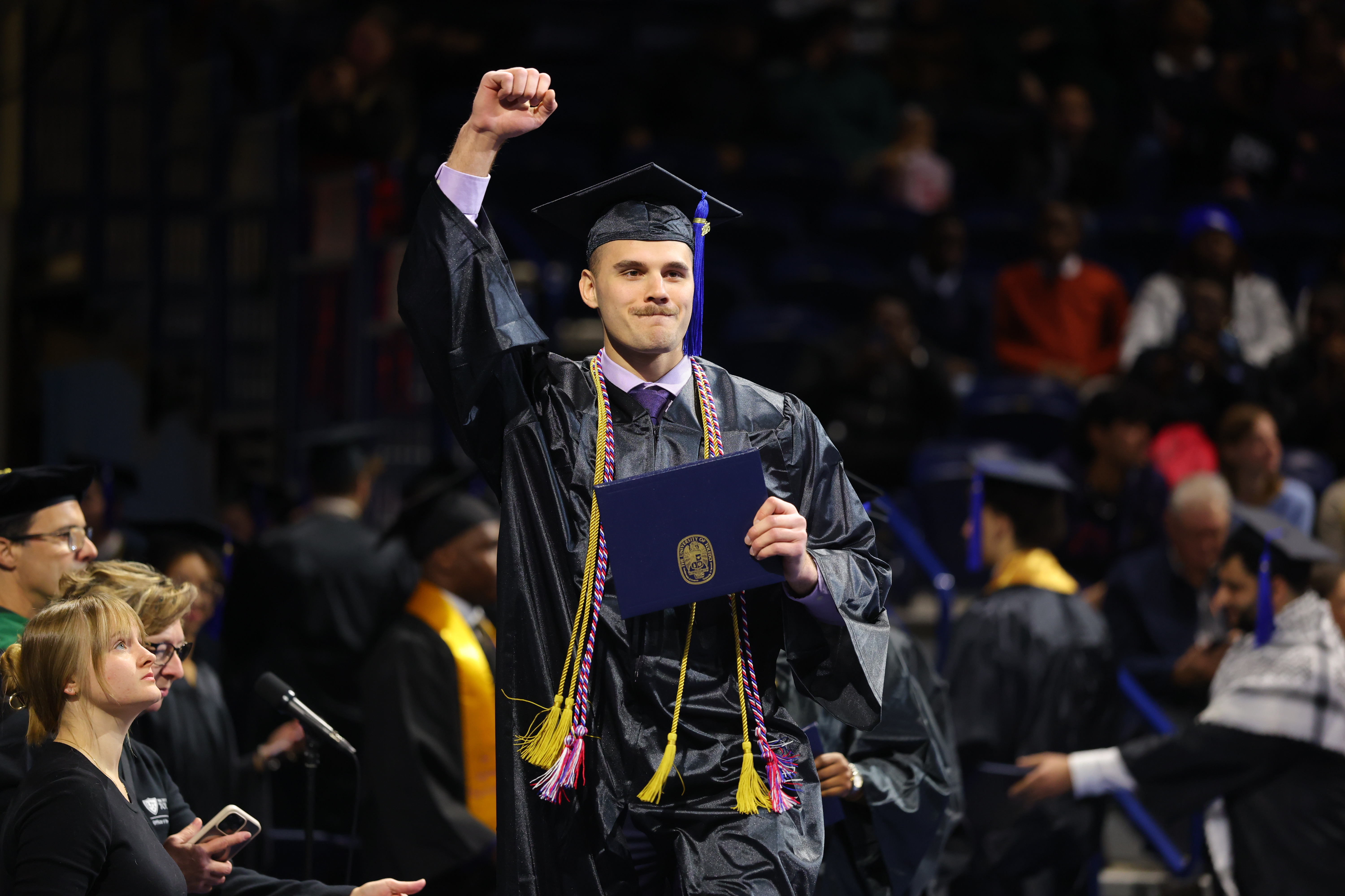 UToledo graduate with diploma a.m. commencement ceremony