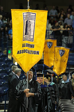 UT Alumni Association flag at commencement ceremony