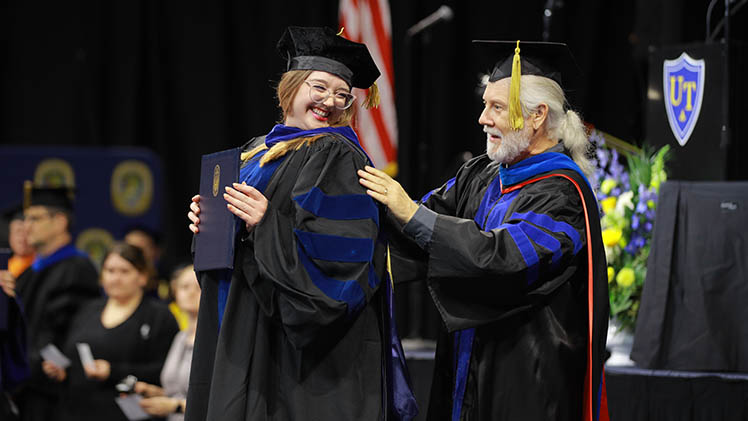 graduate student commencement student getting hooded