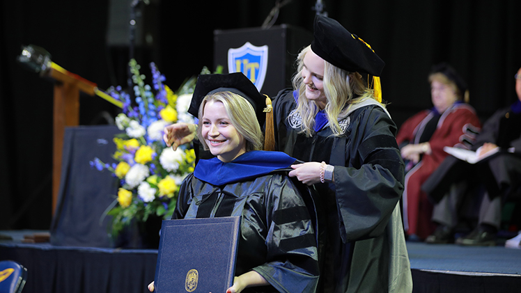 studentt hooding at graduate and doctoral hooding ceremony