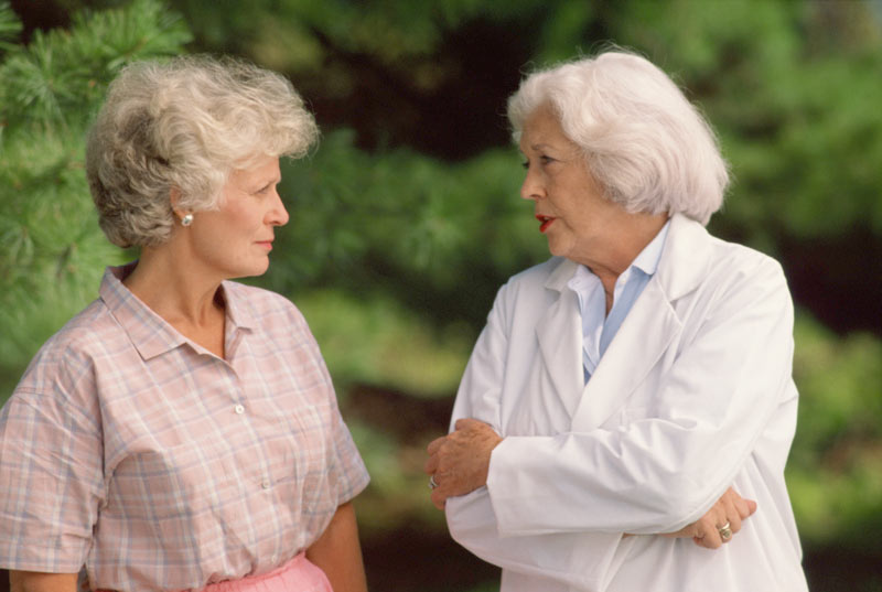 supportive conversation between two elderly ladies