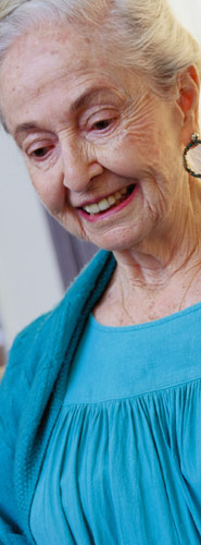 Image of aging woman in blue dress smiling 