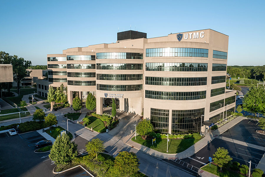 Modern UTMC building with glass windows and landscaping