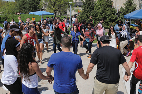 diverse group of students celebrating in the mall area