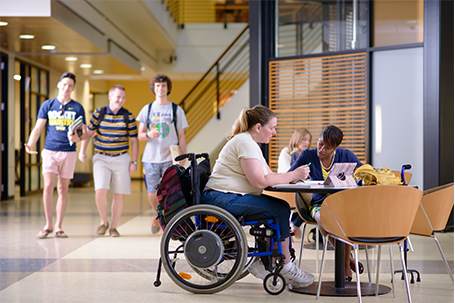 students in Memorial Field House studying, one student is in a wheel chair