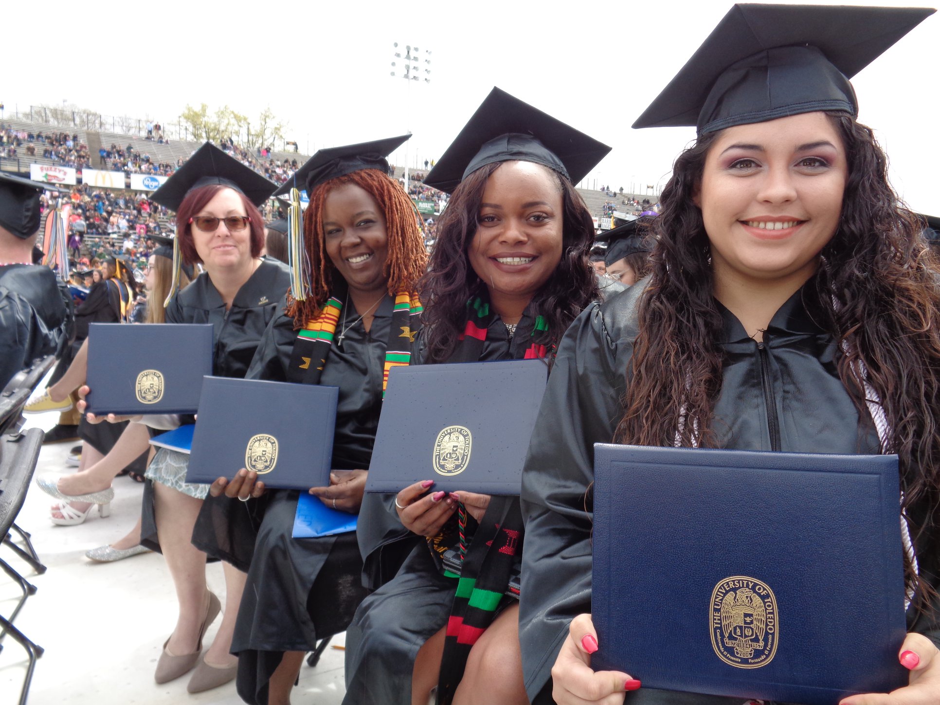 Teach Toledo graduates posing with degrees