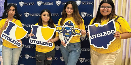 students holding utoledo signs