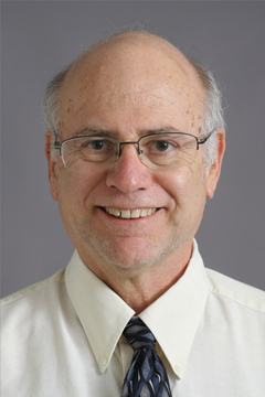 dougnims smiling man with glasses in white shirt and blue tie