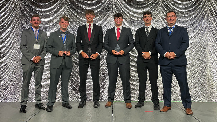 Student Engineers Celebrate First-Place Win at National Surveying Competition standing with a tropy taking a group photo