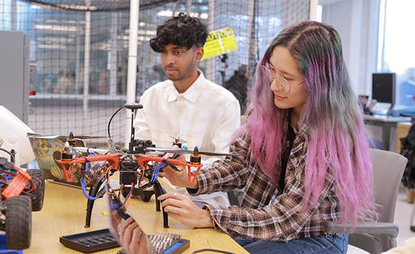 Members of the Learning and Optimization on Networks and Graphs Laboratory working with lab equipment