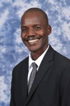 smiling man in dark suit and tie