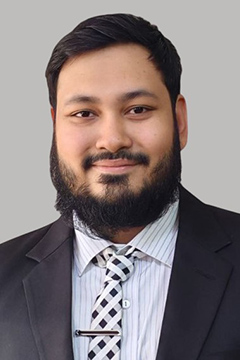Ahmed posing in front of white background.