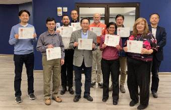 group of faculty members holding certificates