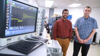 two smiling men in computer lab