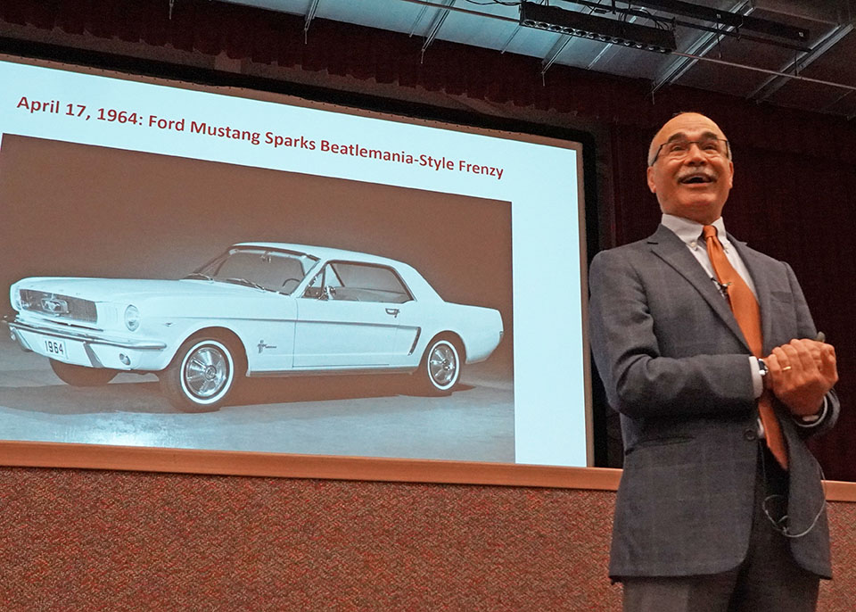 Mehdi Ahmadian in front of slide on Mustang