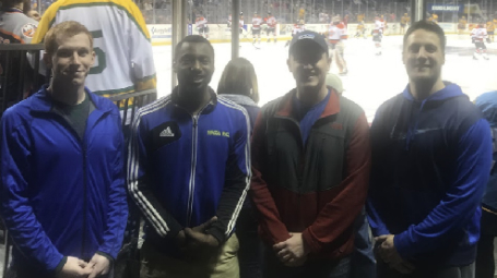 group members at hockey game