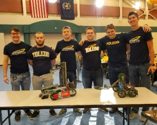 6 members of robotics team with robots