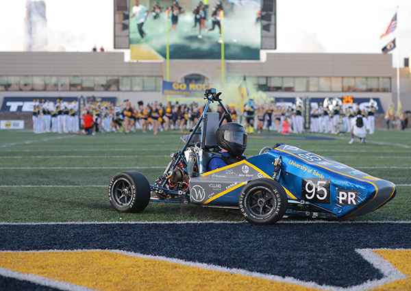 Formula SAE car driving on the glass bowl football field