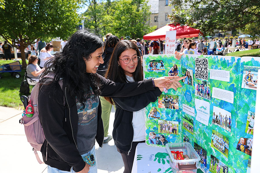 two students engaging with an interactive booth at an involvement fair