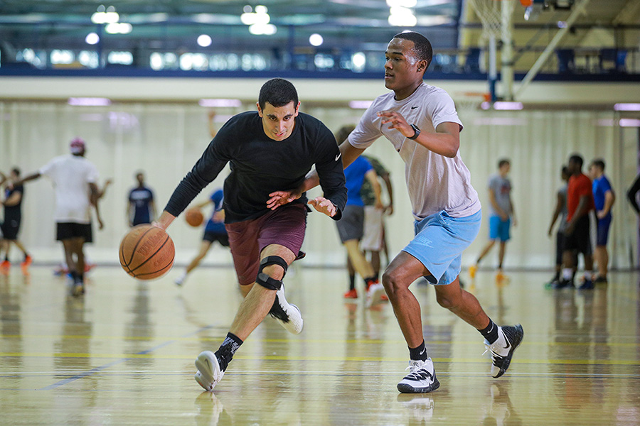 two guys playing basketball at the rec center courts