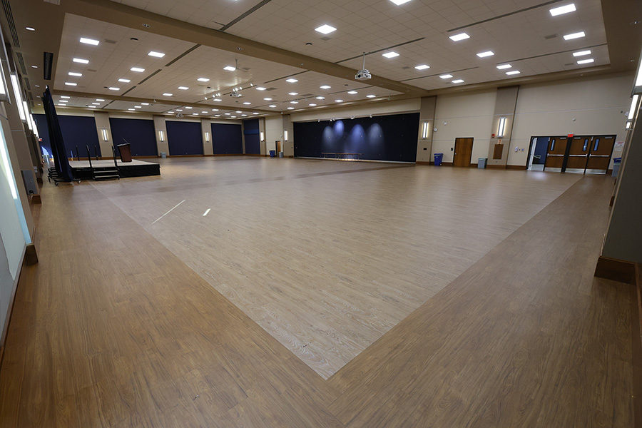 empty auditorium with stage and wood floors