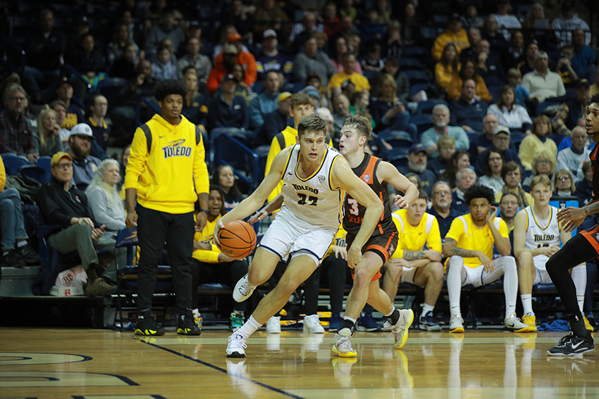 UToledo men's basketball senior JT Shumate swiftly moving with the ball during a basketball game