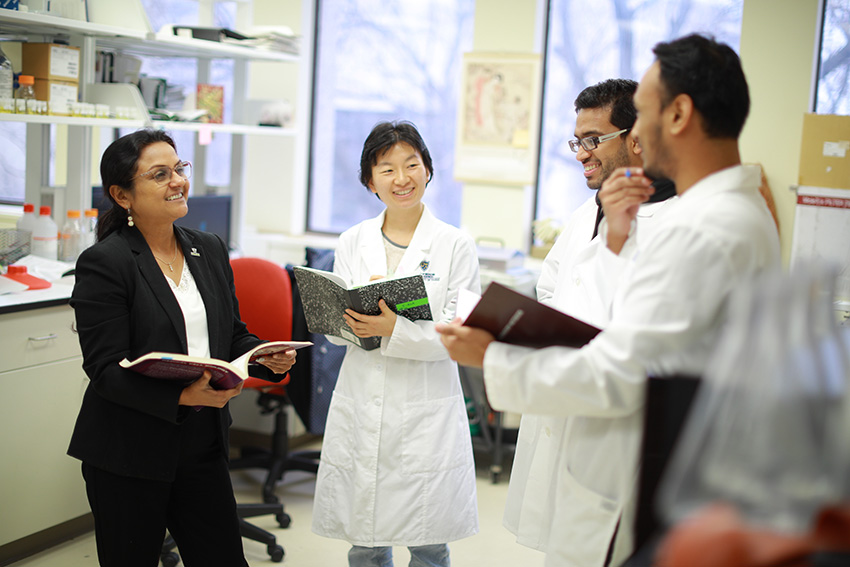 UToledo scientists conversing in a clinical setting.