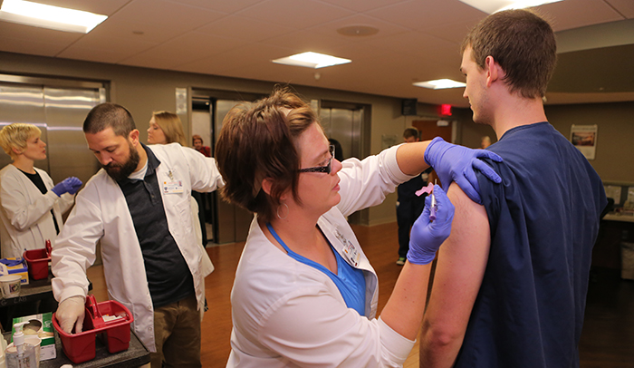 UTMC physician administering shot to patient