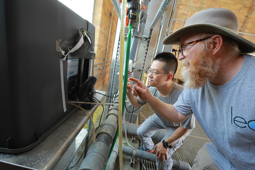 Two ecology researchers intently looking at research equipment.