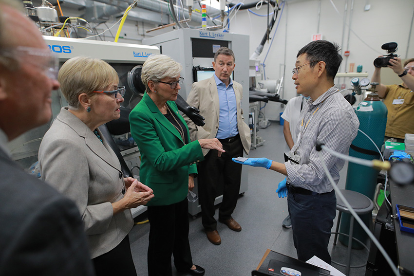 Dr. Yanfa Yan, professor of physics, explaining his research to U.S. Secretary of Energy Jennifer M. Granholm and U.S. Representative Marcy Kaptur.