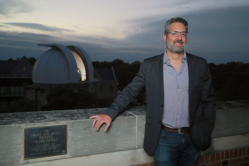 J.D. Smith, Ph.D., standing on the roof of a building on UToledo's campus in the evening