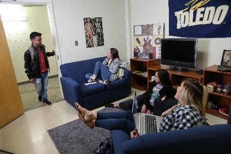 four students inside dorm room 
