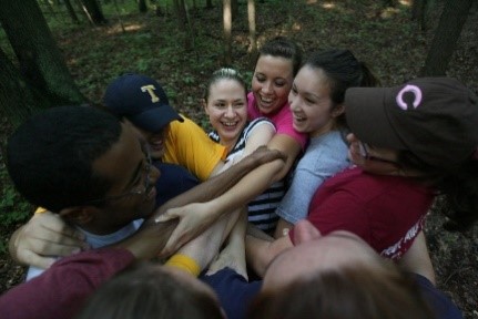 Student-leaders at a camp retreat doing trust exercises.