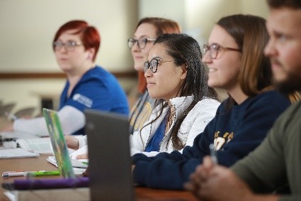 5 students sitting at desk