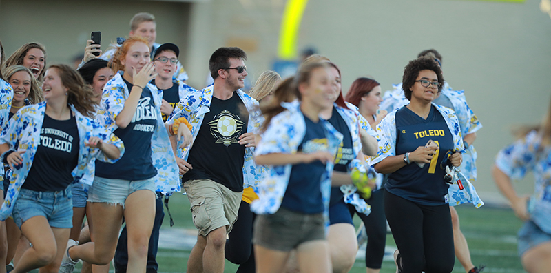 students running on the football field