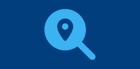 Light blue flat icon of magnifying glass over location pin icon and dark blue background
