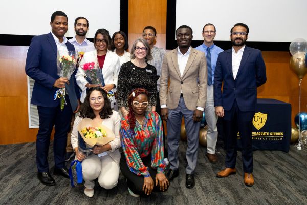 Group of UToledo Three Minute Thesis finalists and winners smiling with director and senior vice provost