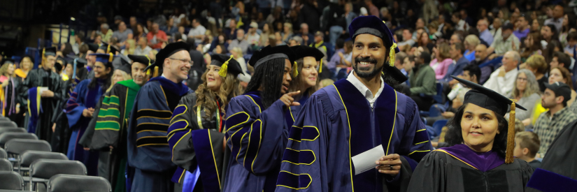 Doctoral candidates lined up awaiting to be seated at commencement